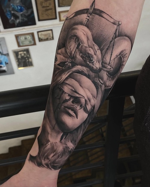 women portrait and snake arm tattoo