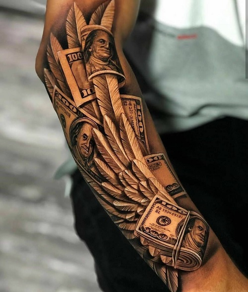  forearm tattoo featuring U.S. dollar bills and feathers