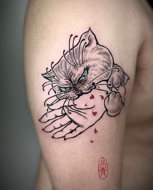 Bitten by cat tattoo