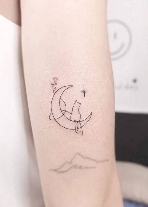 cat sitting on a moon tattoo